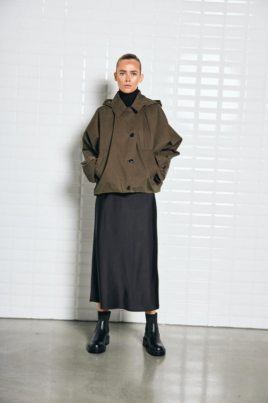 With Black Alaia in Midnight Green